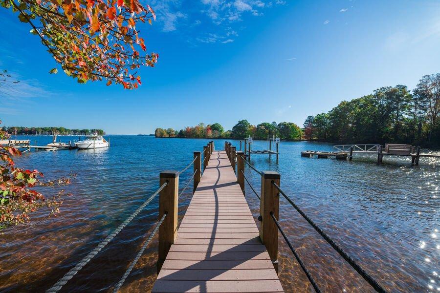 Wooden dock leading out to Lake Norman with colorful fall foliage