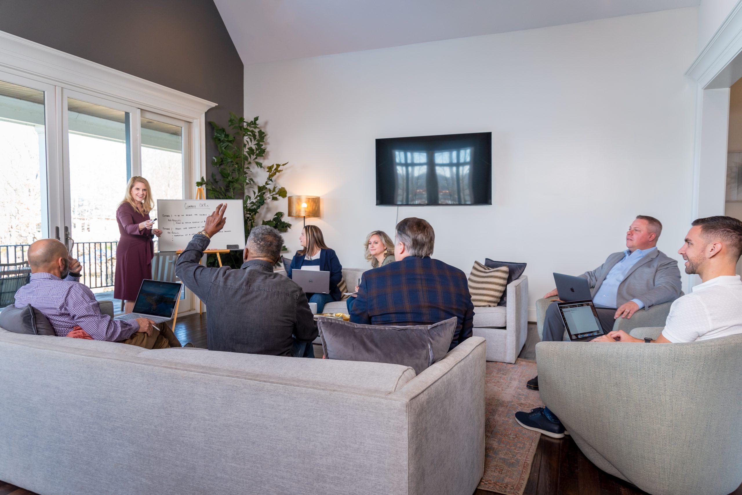 Team gathered during company retreat at StayLakeNorman vacation rental, Mallard Vestige.