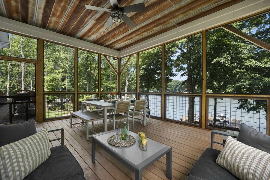 luxury is indoor/outdoor living with a lake view 