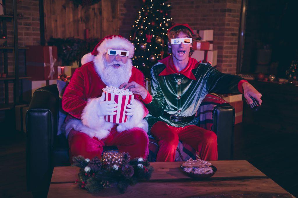 Santa Claus and Elf with 3d glasses watching television