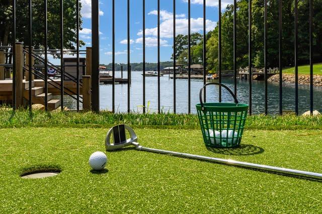 Waterfront putting green at Shoreline on Stonemarker, a StayLakeNorman Luxury Vacation Rental in Lake Norman, NC.